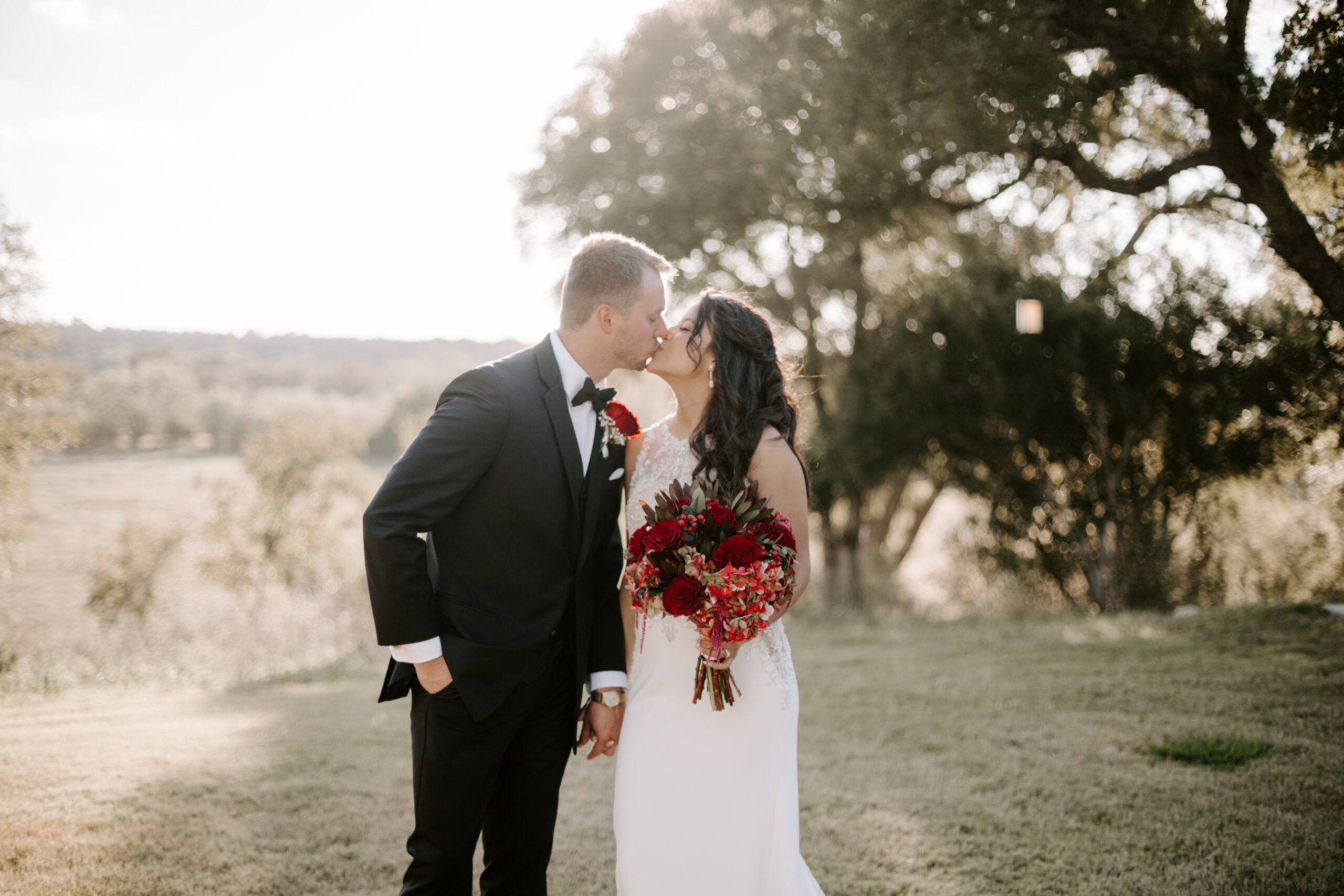 southern bride and groom portraits with beautiful red flowers