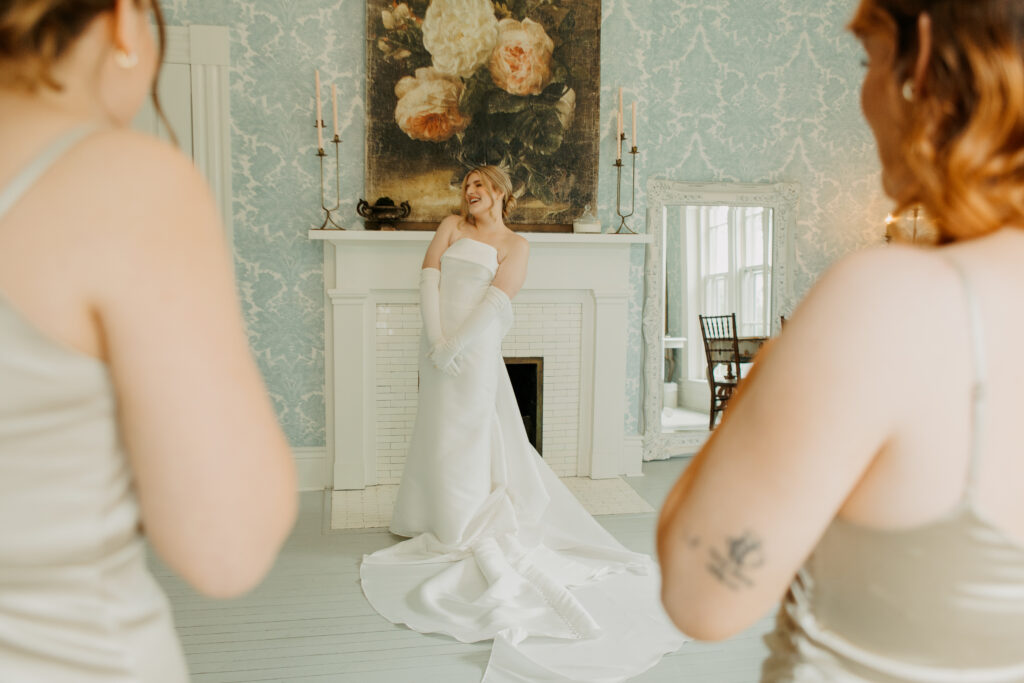 Bride shows off for bridesmaids after getting ready photos