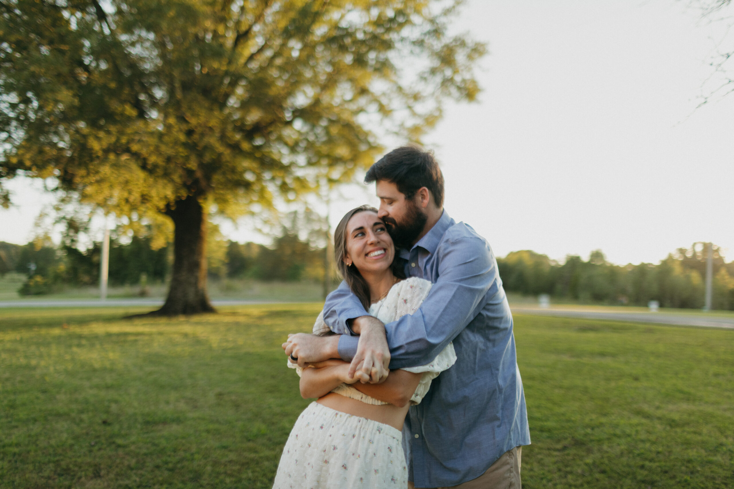 Couple laughing during their Memphis engagement session in Overton Park
